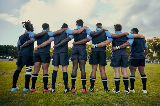 Back view, men or rugby team in stadium with support, unity or pride ready for a sports game together. Fitness, solidarity or proud players in line for match, workout or exercise on field at stadium