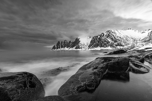 Sunset over the Okshornan mountain range at Tungeneset on the island of Senja in Northern Norway at the end of a beautiful day in winter.