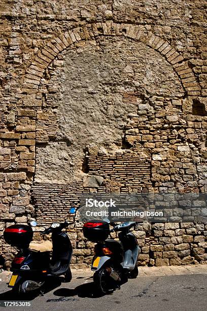 Two Motor Bikes Parked At A Roman Ruin Wall Stock Photo - Download Image Now - Architecture, Barcelona - Spain, Brick