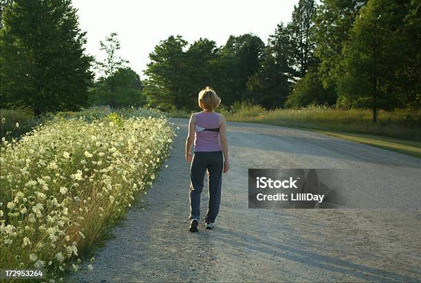 Walking Down The Road Stock Photo - Download Image Now - 40-49 Years, 50-59 Years, Active Lifestyle