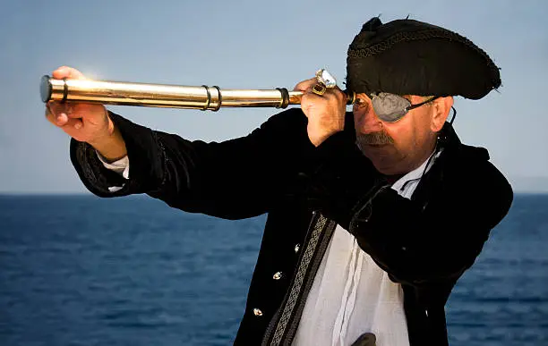 A pirate captain of the Mediterranean, looking through a hand-held spyglass / telescope.