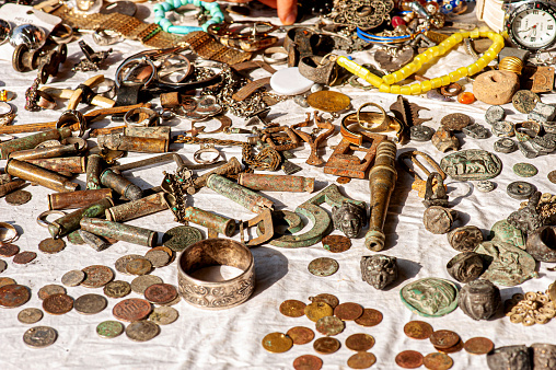 Athens, Greece - October 19, 2018: A pile of trinkets and antiques for sale at a marketplace in the Monastiraki neighborhood, known for its antique shopping and flea markets.