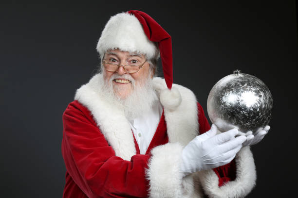 istock Santa Claus holding a Christmas ornament 1729543173