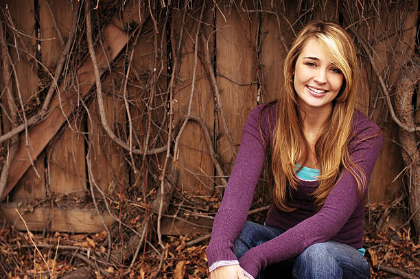 portrait of the girl on a background of a brick wall. sepia effect