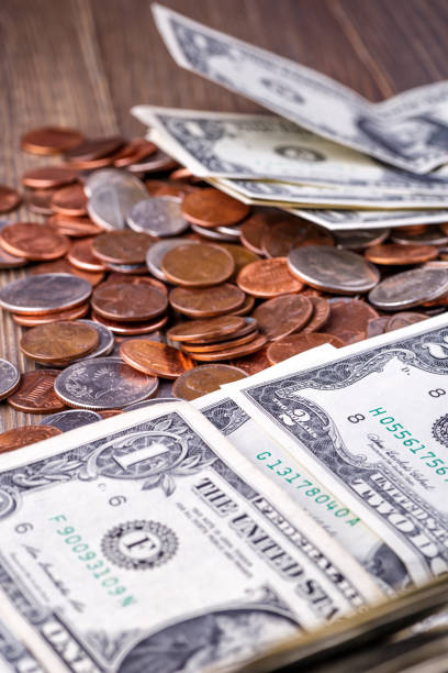 istock American coins and US dollars on a wooden table 1729549102