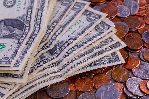 istock American coins and US dollars on a wooden table 1729549195