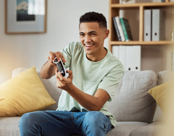 istock Couch, esport and man playing video game online with controller in living room virtual challenge and excited in home. Internet, user experience and happy person or gamer streaming sports games 1729549205