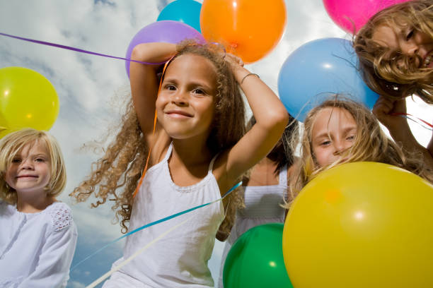 istock Little girls with multicolored balloons 172955135