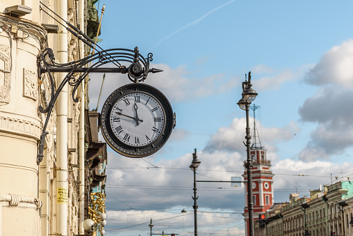 Russia, Saint Petersburg, September 2023: wall street clock on the wall of the building on Nevsky Prospekt