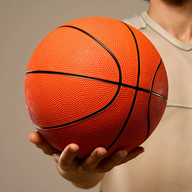 istock Basketball in a person's hand on a beige background 172955863