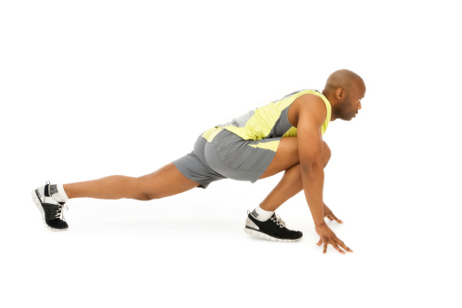 Photo man performing a runner's stretch exercise.