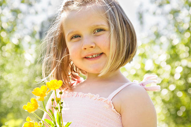 Happy Little girl picking buttercups on a sunny day