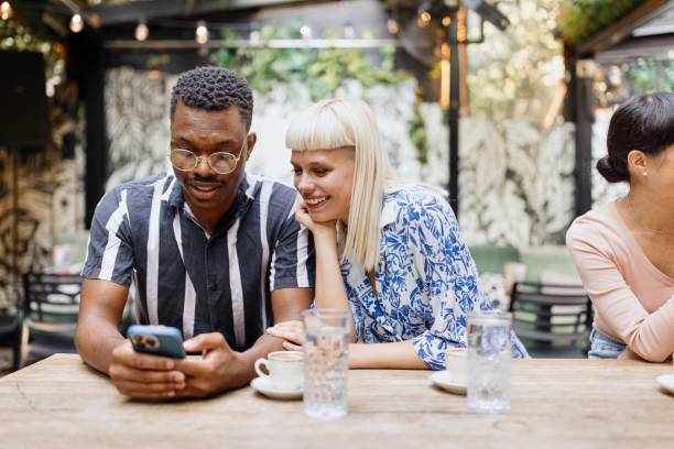 istock Modern friends sitting at the cafe and surfing the net 1729567257