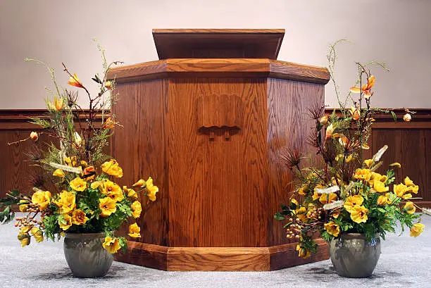 "A pulpit, or podium, where the preacher stands to deliver his sermon.  Found in many churches.  USA"