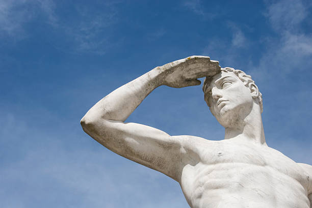 istock Muscular Man White Marble Statue Shielding Eyes Blue Sky 172957133