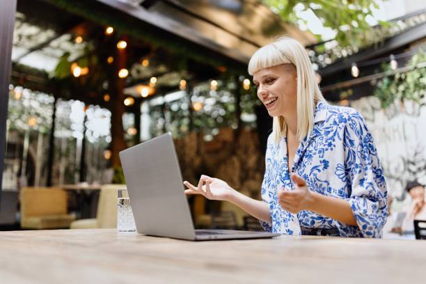 Woman talking with someone on a video call at the caffe