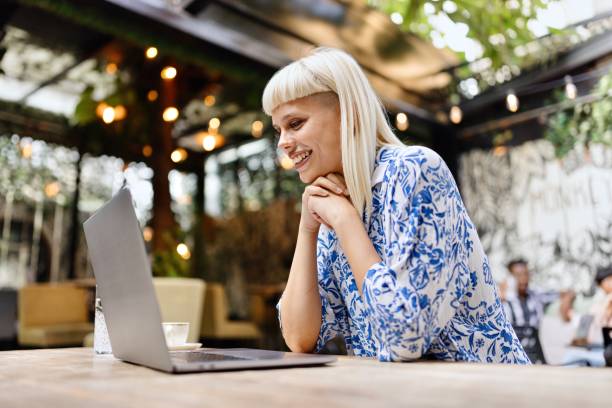 Beautiful woman working on a laptop at the caffe