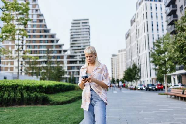 istock Modern woman using her smartphone in the city 1729575900