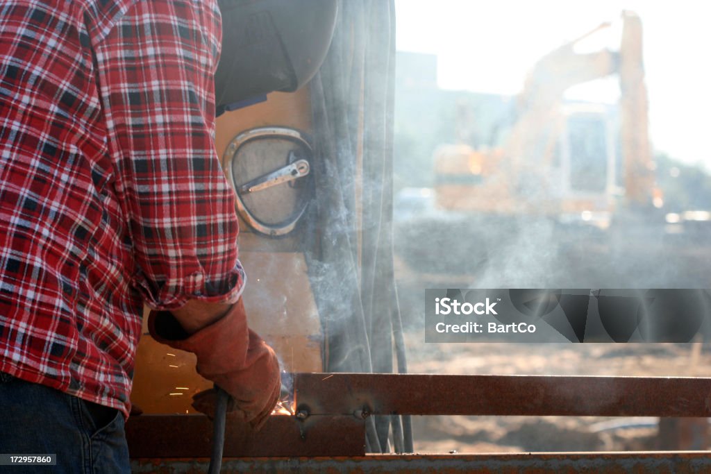 Construction worker on a building pit. "The construction industry is the key indicator and driver of economic activity and wealth creation. This industry has a profound impact on our daily lives: the buildings we live and work in, the roads and bridges we drive on, the utility distributions systems we use, the railways, airports and harbours we travel and trade from are all products of this vital industry.Engineers and developers are the key persons in the process of design.If you want more images with a construction worker (with tools) please click her." Adult Stock Photo