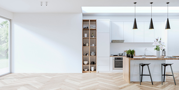 Modern white and hardwood kitchen with stools in front of a rectangular breakfast kitchen island with spices, coffee cups, and a vase of lilies, on the hardwood herringbone floor. Four pendant black lights, kitchen hood, utensils, dishes, plates, and stoves on wall hardwood shelves and in open hardwood kitchen cabinets on one side.  An empty large white wall in front of large windows on the side, a nice view of a luxurious garden in the background, and a large ceiling window over the whole kitchen. 3D rendered image.