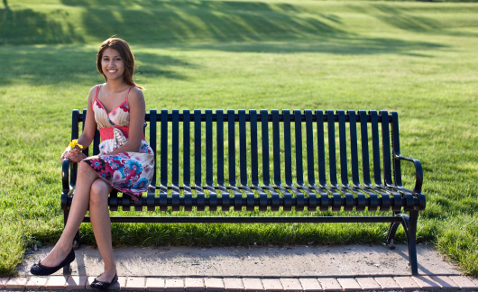 Asian Indian woman on a park bench enjoying the day