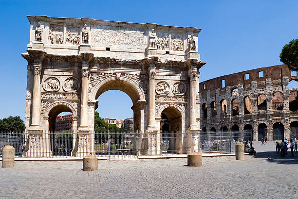 Constantines archway and colasseum. Emperor Constantines archway. This stands by the side of the colosseum in Rome and dates back to the time of the great emperors. ancient rome stock pictures, royalty-free photos & images