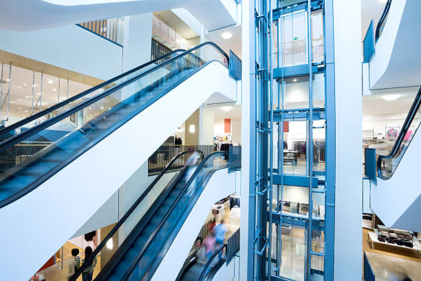 Escalators and elevator in shopping center stock photo