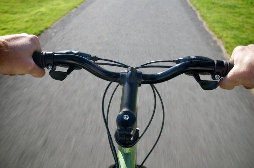 A point-of-view shot riding a bicycle with motion blur.