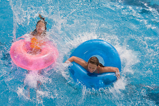 Ready Set GO! Two sisters having a blast jumping in the pool. Please see similar and newly added shots in my Splish Splash Summer lightbox. Click here: just do it stock pictures, royalty-free photos & images