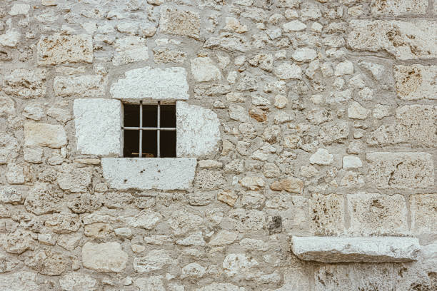 istock Old stone residential building and window in the wall 1729596212