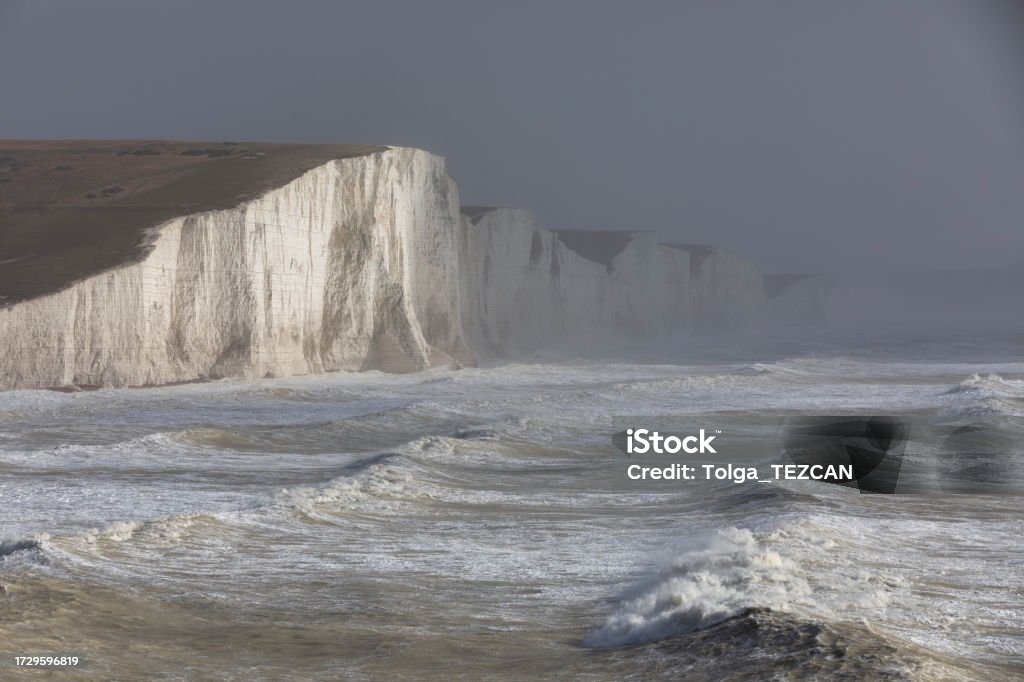 English Channel storm , South Downs Dramatic waves in the English Channel set against the majestic white cliffs known as the Seven Sisters, East Sussex, UK Atmospheric Mood Stock Photo