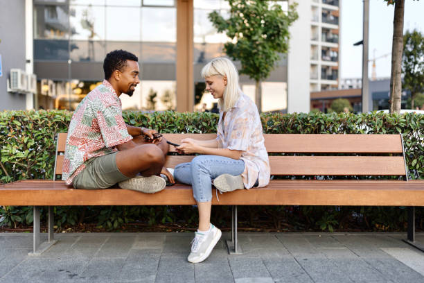 istock Joyful people sitting and talking about something in the city 1729597268