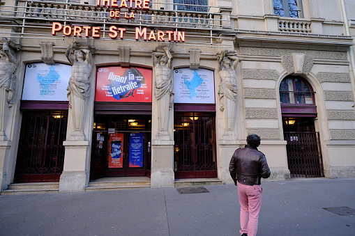 Paris, France - January 21, 2022: A man looking at the facade of a french theater.