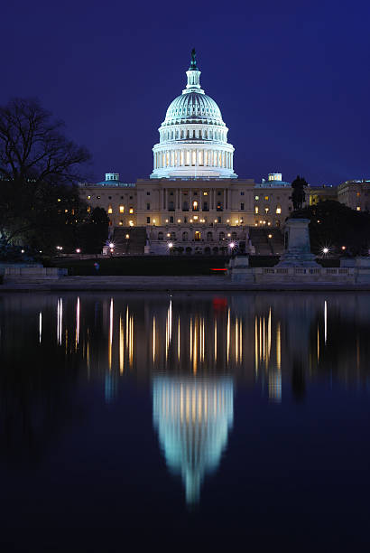 istock U.S. Capitol at night, with reflection in water 172960754