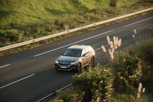 LA, CA, USA\n4/3/2022\nWhite BMW E92 M3 driving on the road with a green mountain in the background