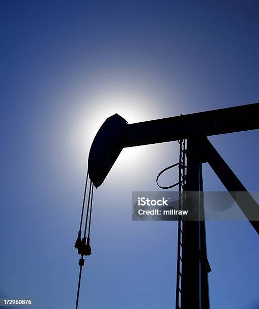 Aceite Pumpjack Silhouetted Contra El Cielo Azul Foto de stock y más banco de imágenes de Alberta - Alberta, Asfalto, Azul