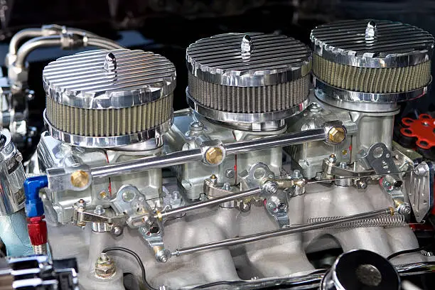 Three 2 barrel Carburetors on an aluminum GTO manifold.