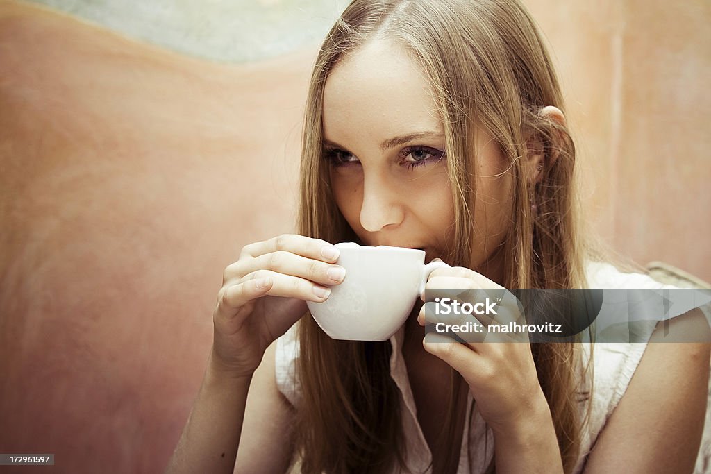 positive young woman drinking coffee coffee session. space for text on the leftFor more photos of this model click here: Adult Stock Photo