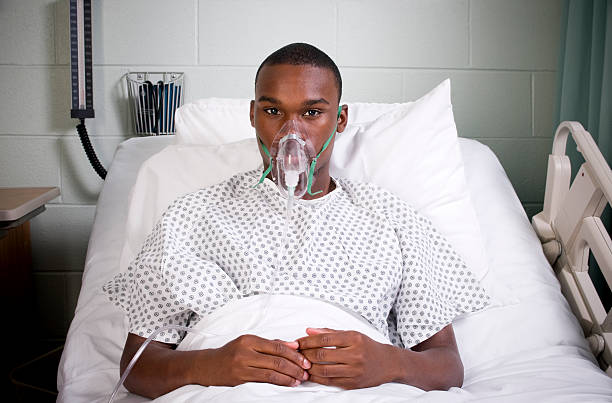 Behind The Oxygen Mask Stock Photo - Download Image Now - Men, Oxygen Mask, African Ethnicity -