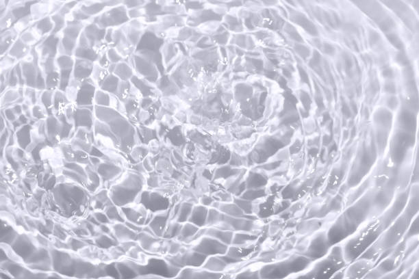 istock Defocus blurred transparent gray colored clear calm water surface texture with splashes reflection. Trendy abstract nature background. Water waves in sunlight with copy space. Blue watercolor shine. 1729618717