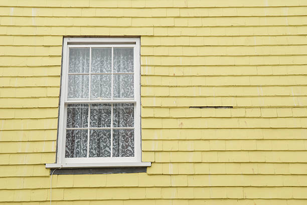 istock Single Window Pale Yellow Wood Shingle House 172962090