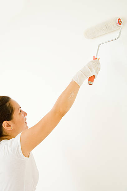 istock isolated girl painting with roller 172962133
