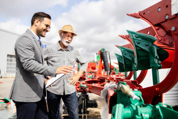 istock Farmer buying new plow equipment for his tractor. 1729621520