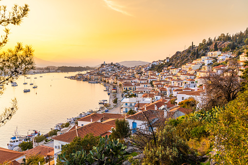 Poros, Greece - 17 February 2023 - Overview of the town of Poros on Poros Island at sunset