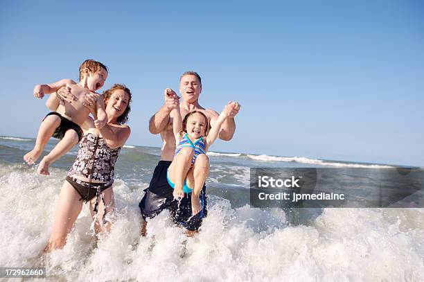 Catch A Wave Stock Photo - Download Image Now - Beach, Couple - Relationship, Playful