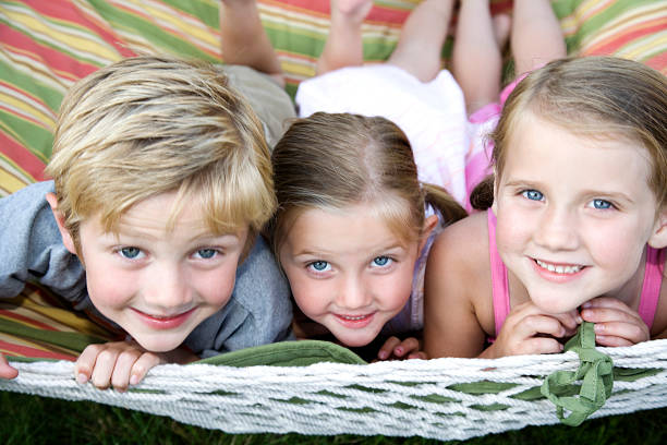 istock Three happy adorable children playing outside 172962859