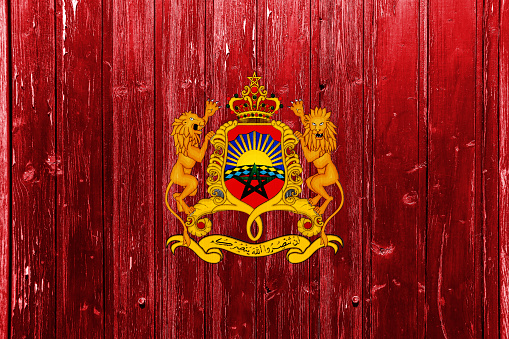 Flag and coat of arms of Kingdom of Morocco on a textured background. Concept collage.
