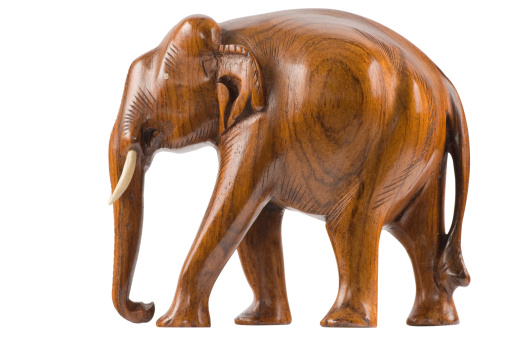 Wooden elephant carved in hardwood. Isolated on pure white.Clipping path included.