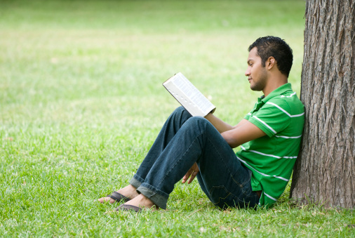 Teen reading outdoors