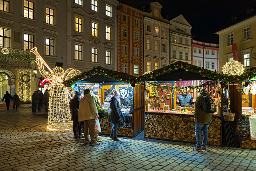 Prague, Czech Republic - December 5, 2017: Small Christmas market at the Male Namesti (Small Square) in night. The Male Namesti is located in Old Town not far from the Old Town Square. Unknown people buy Christmas presents and souvenirs.